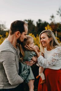 mom holding daughters face during a family photo session